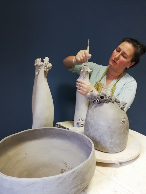 Artystka Aneta Śramska-Piątek w swojej pracowni podczas produkcji ceramiki artystycznej. Zdjęcie do biogramu artystki na stronie internetowej Galerii Wiele Sztuki. 